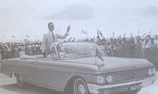 Nyerere waves to the crowd as he is driven around the Dar-es-Salaam stadium